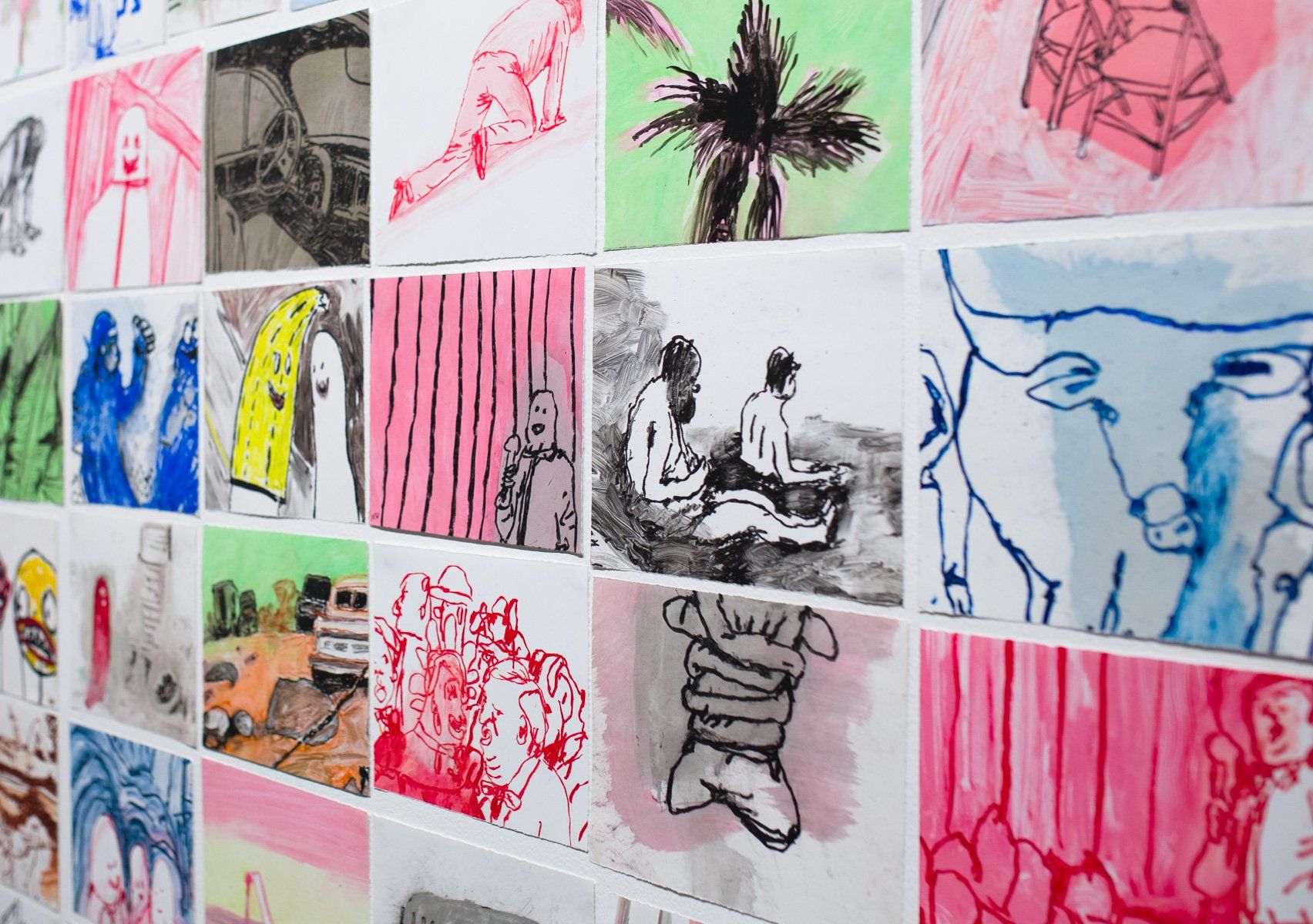 A wall with a bunch of drawings on it