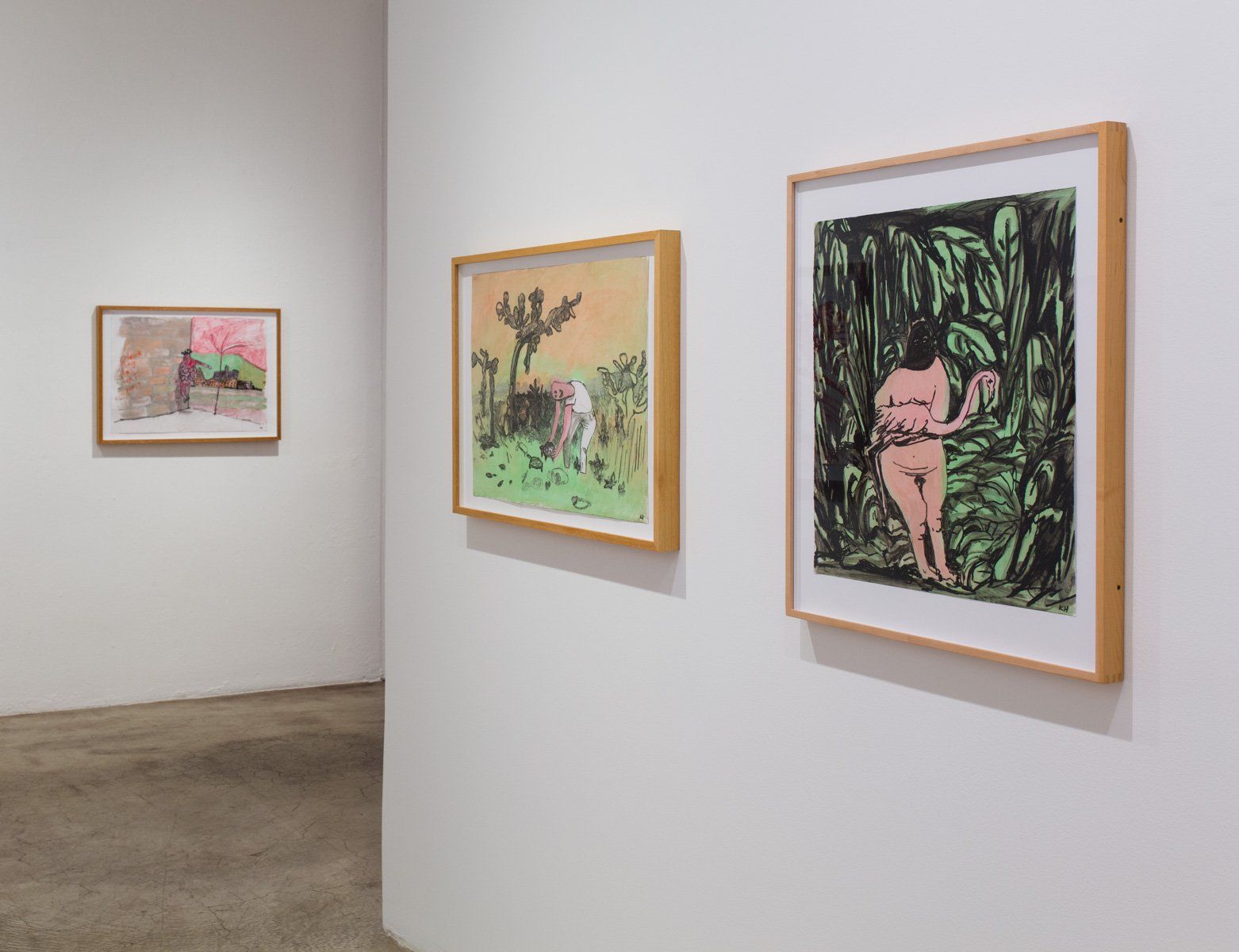Three paintings are hanging on a wall in a museum.