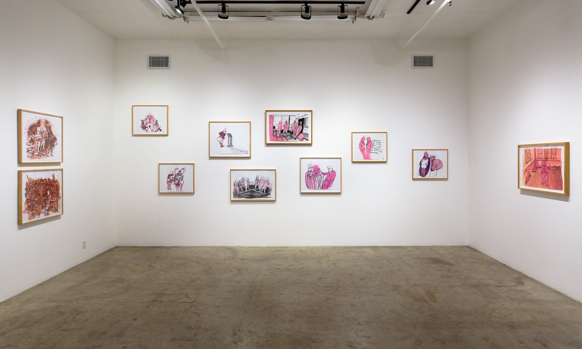 A large empty room with a lot of paintings on the wall.