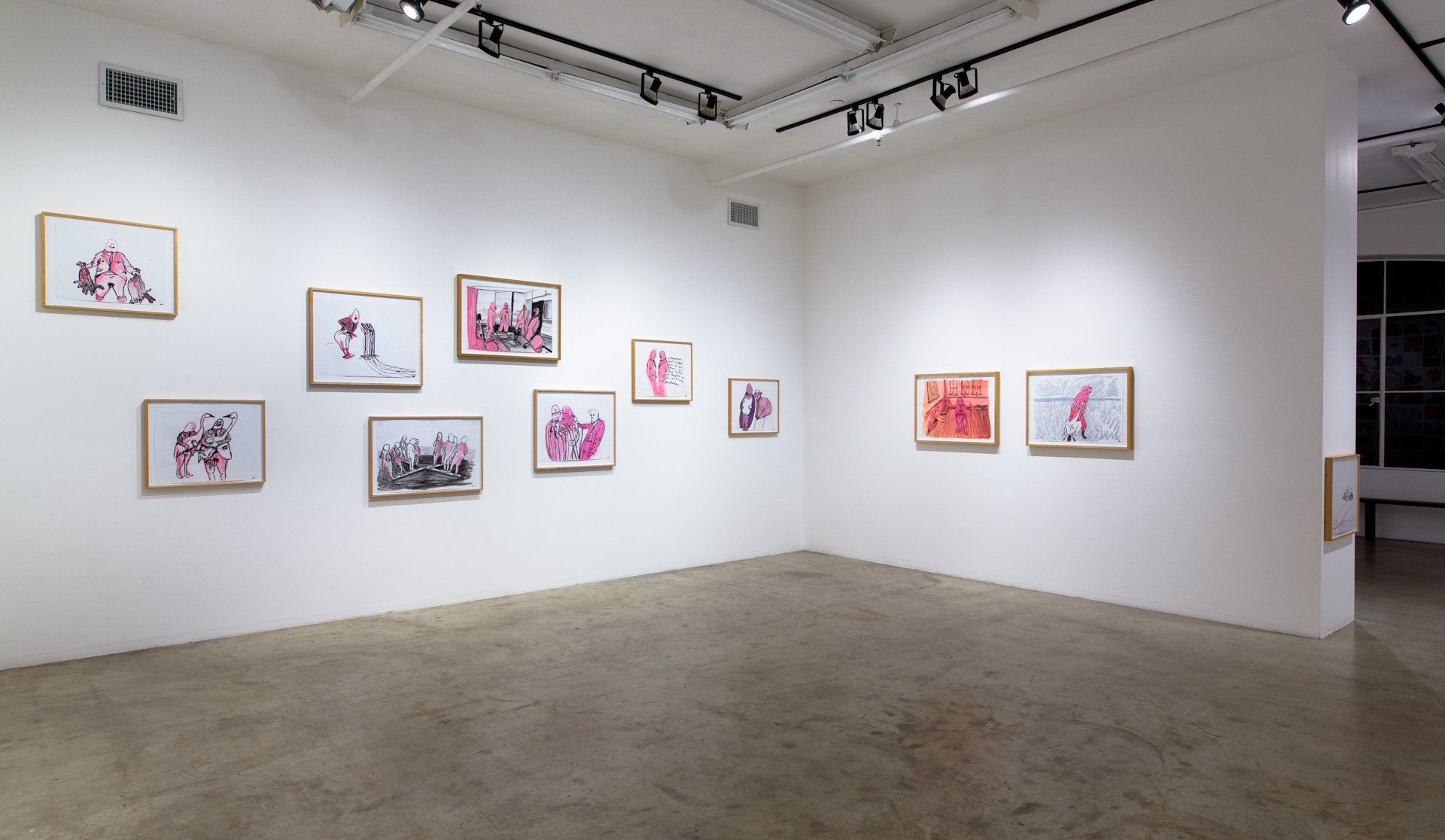 A room with a lot of paintings on the wall