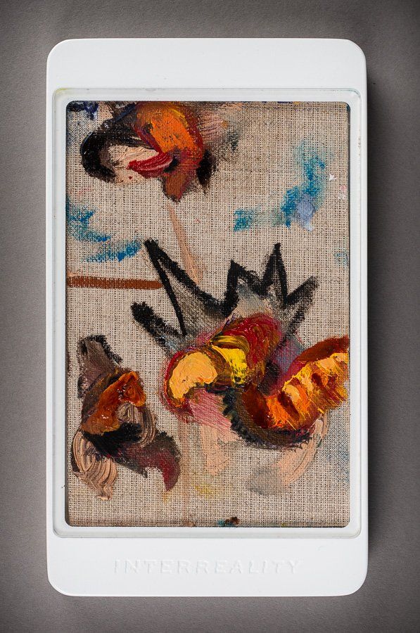 A white cell phone with a picture of a painting on it.