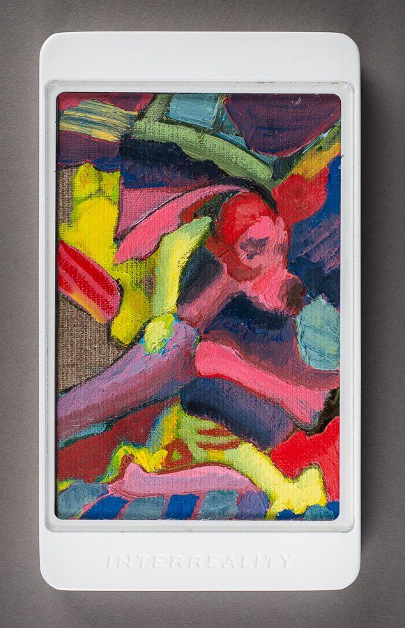 A white tablet with a colorful painting on it.