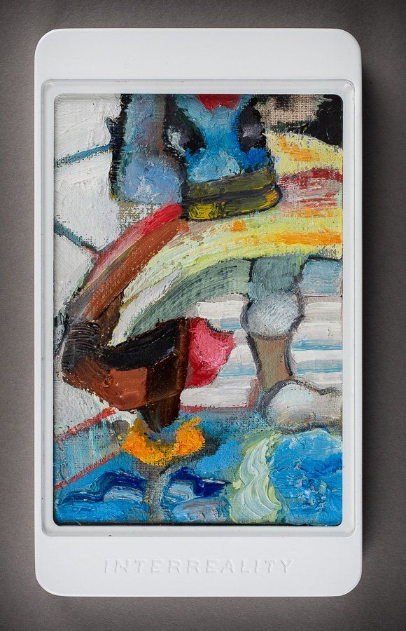 A white cell phone with a painting on the screen.