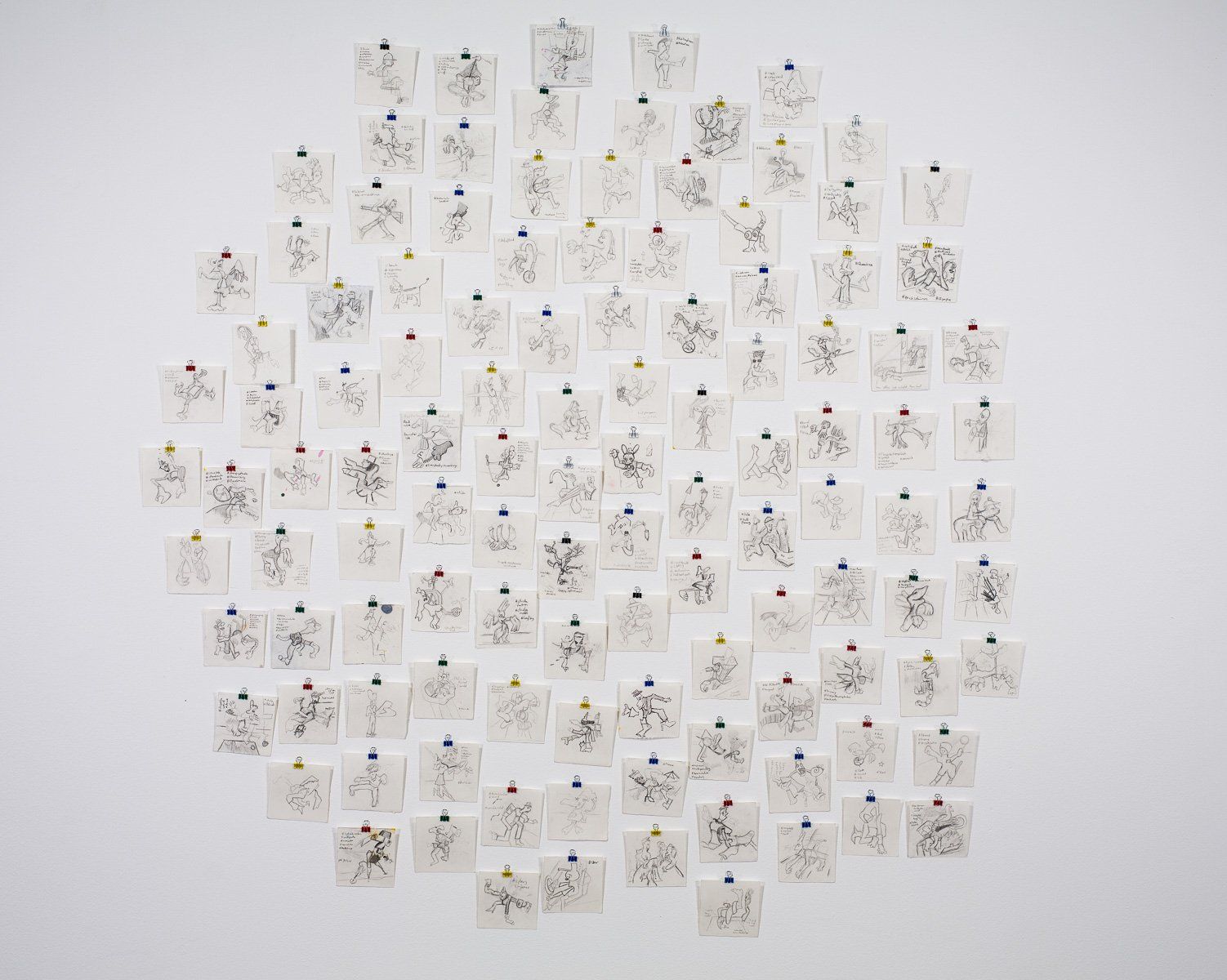 A bunch of pictures are hanging on a white wall.