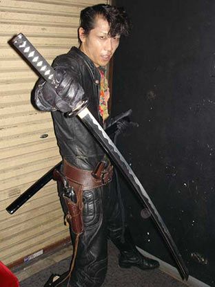 A picture of a man holding a sword pointing down.