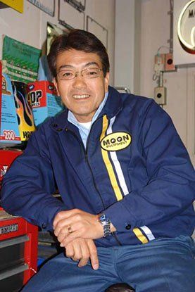 A man wearing a blue jacket with the word moon on it