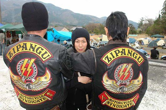 Three people wearing zipangu jackets are standing next to each other