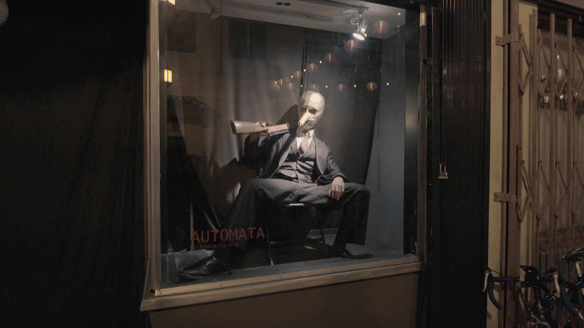 A man is sitting in a chair in a window.