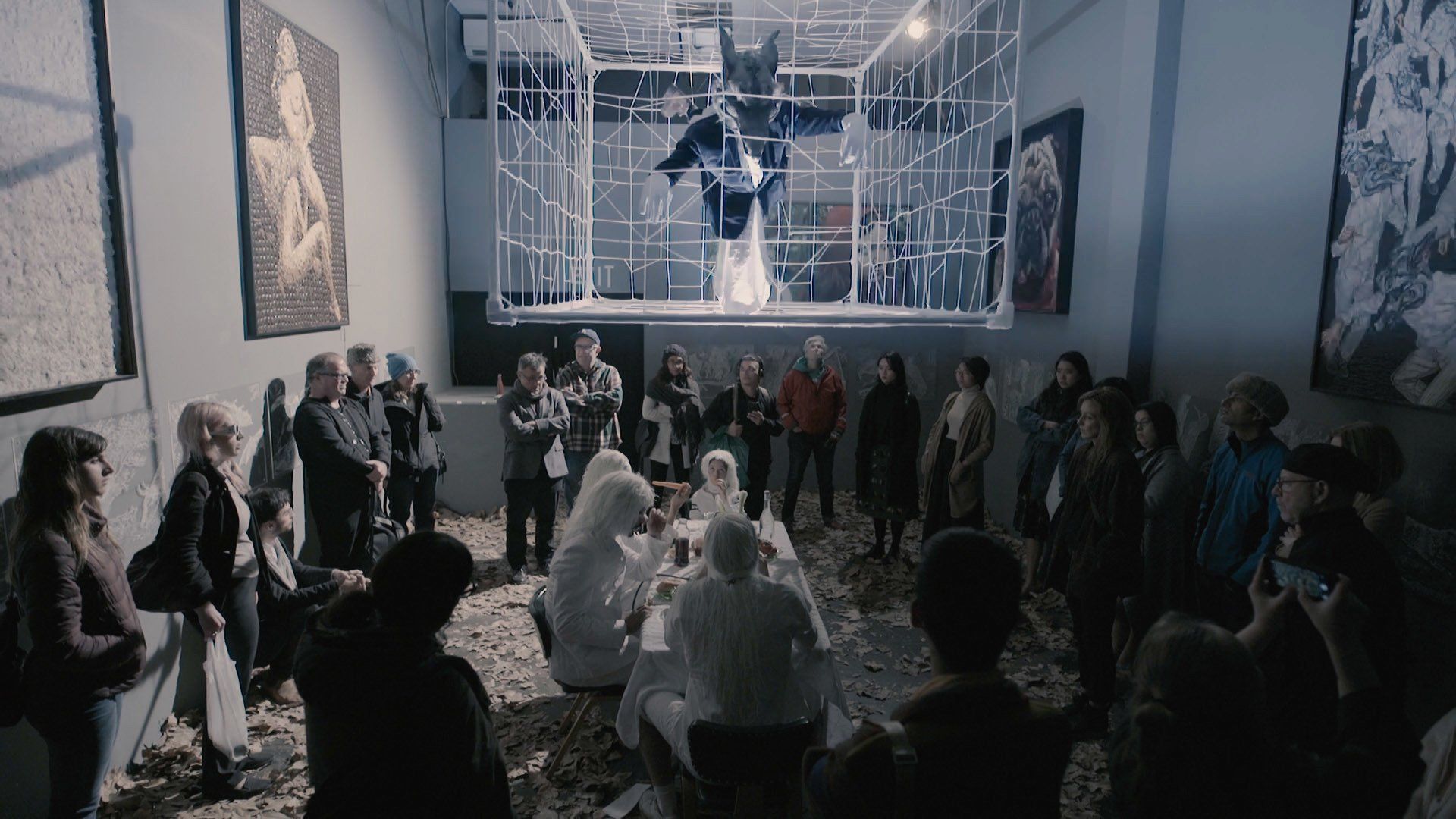 A group of people are sitting in a room watching a performance.
