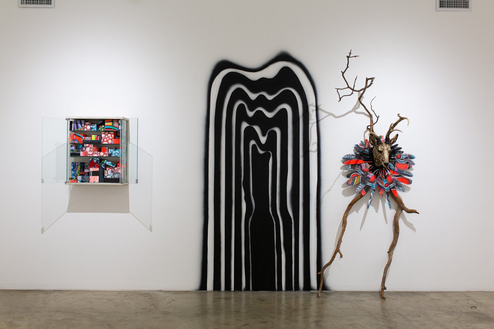 A wall with a painting and a sculpture on it