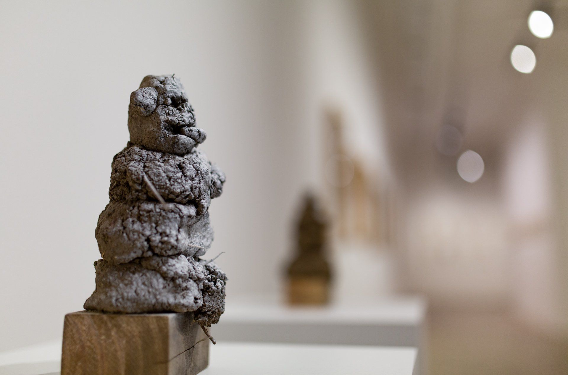 A statue of a man is stacked on top of each other on a wooden block.