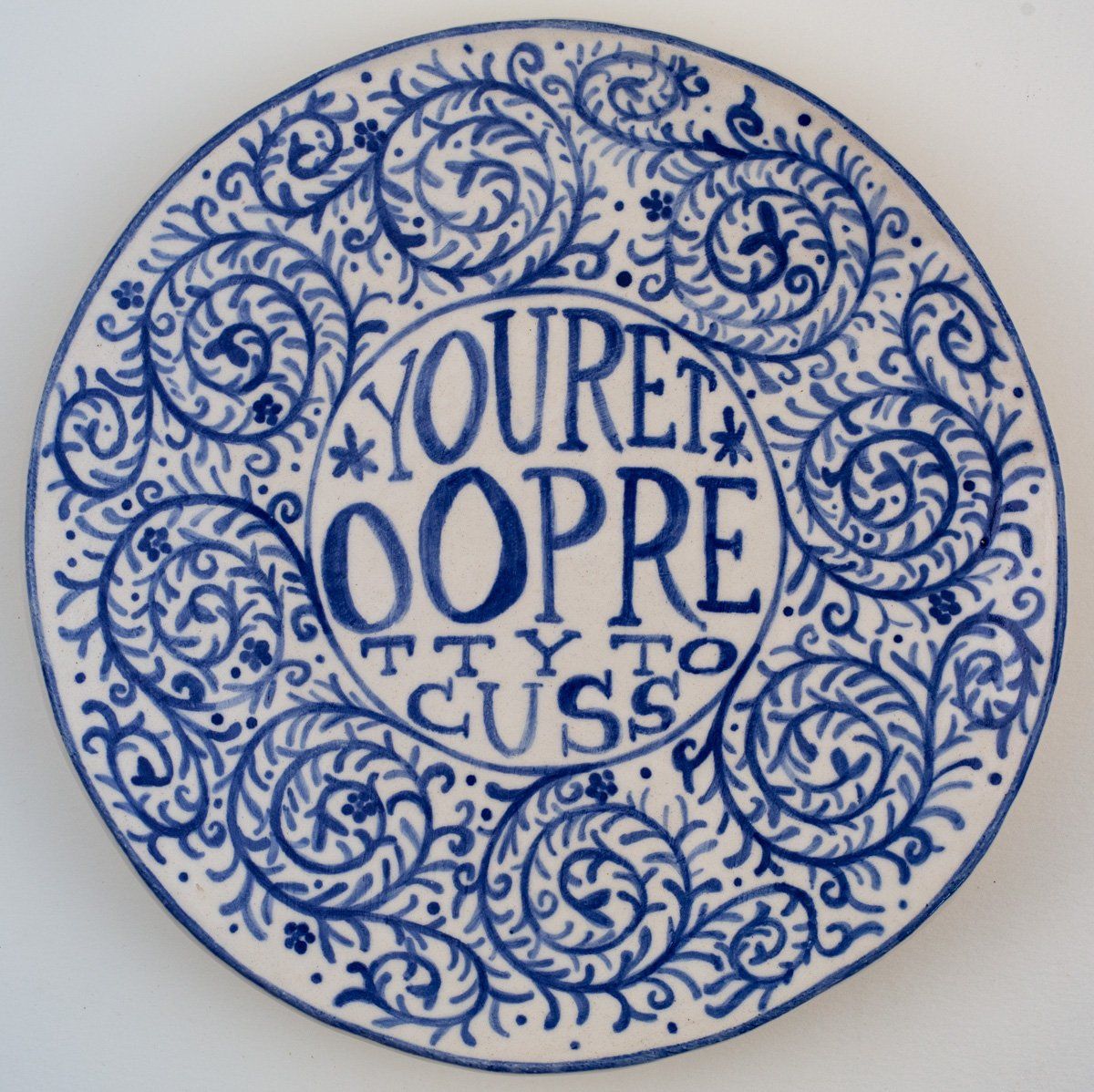 A blue and white plate that says