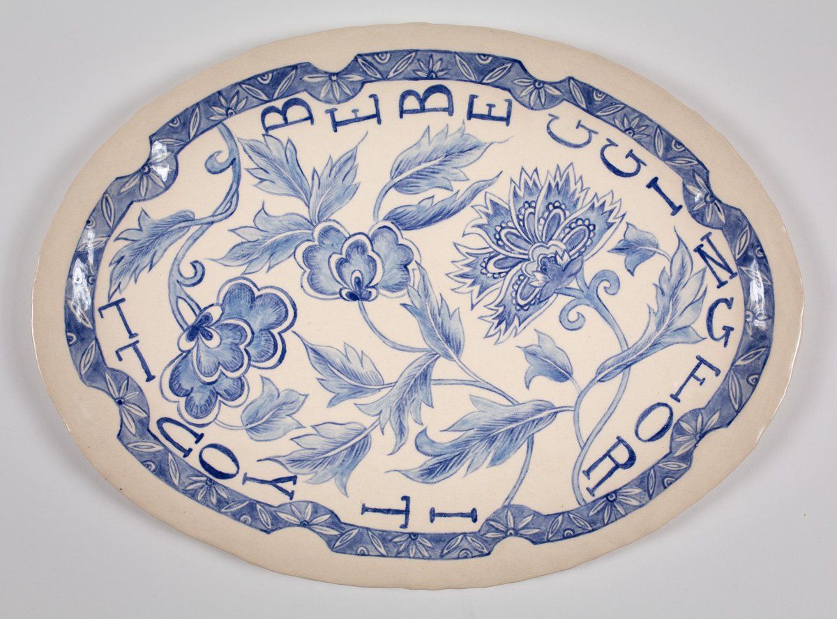 A blue and white plate that says 