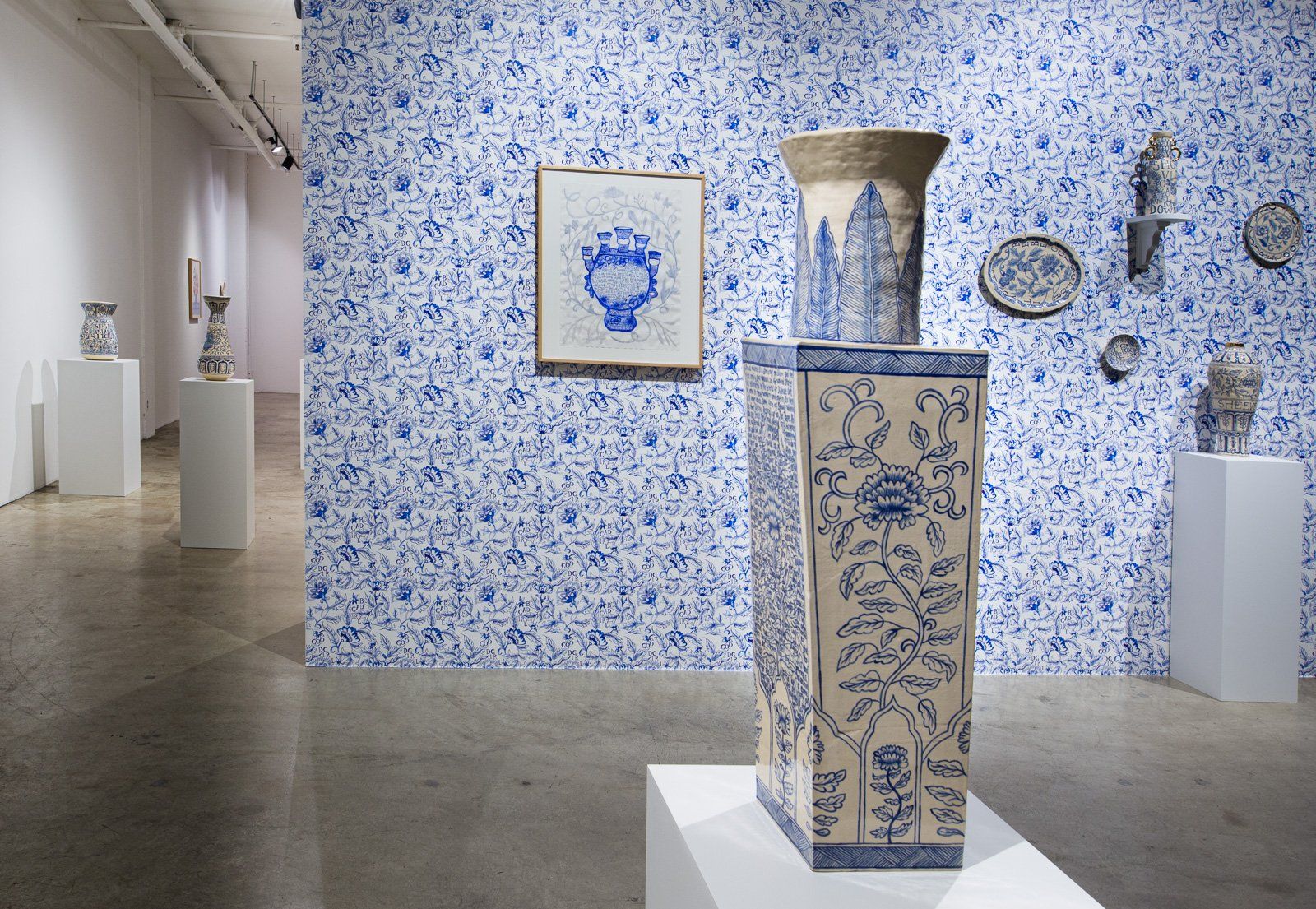 A blue and white vase is on display in a museum.