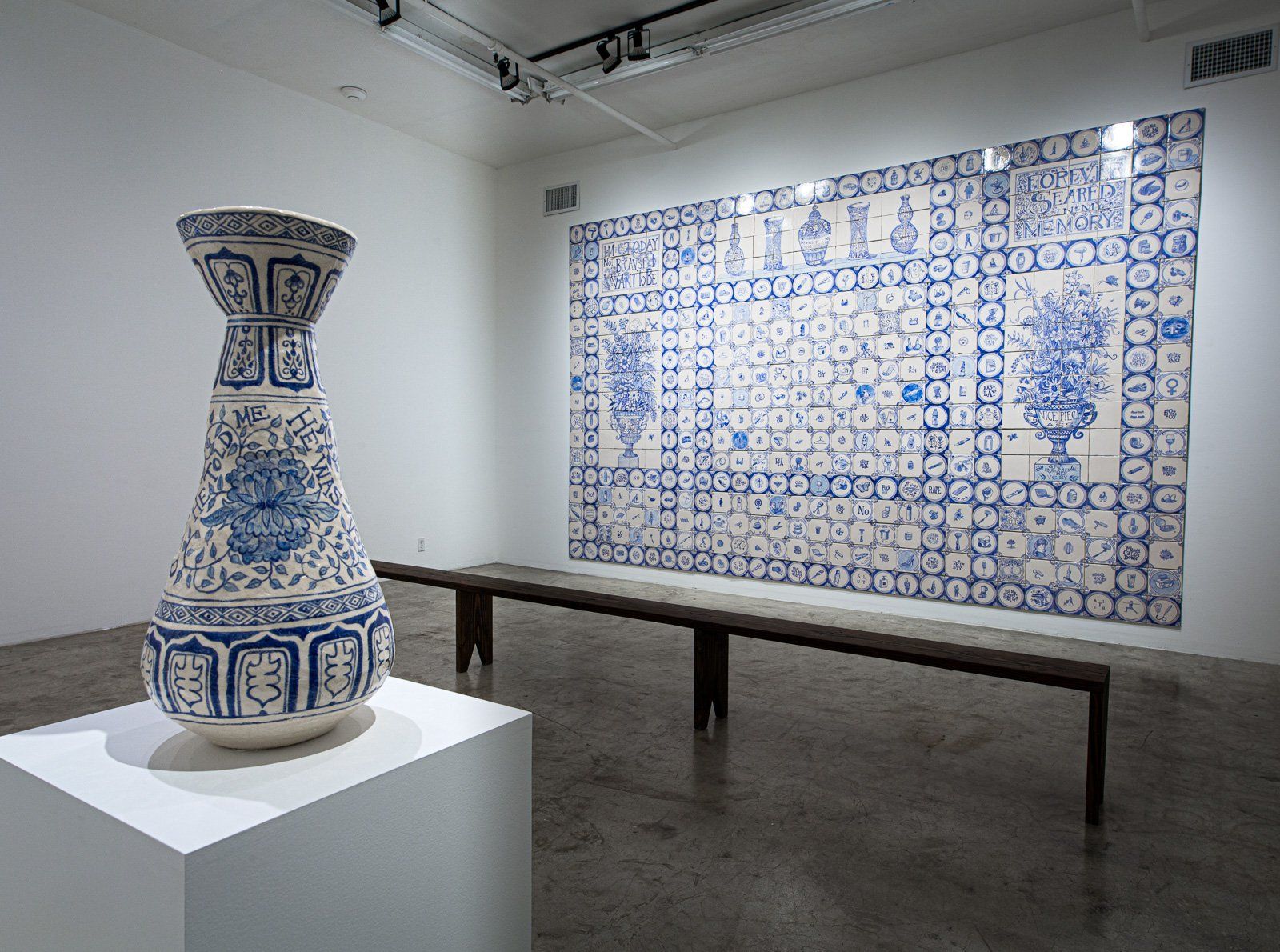 A blue and white vase is on display in a museum.