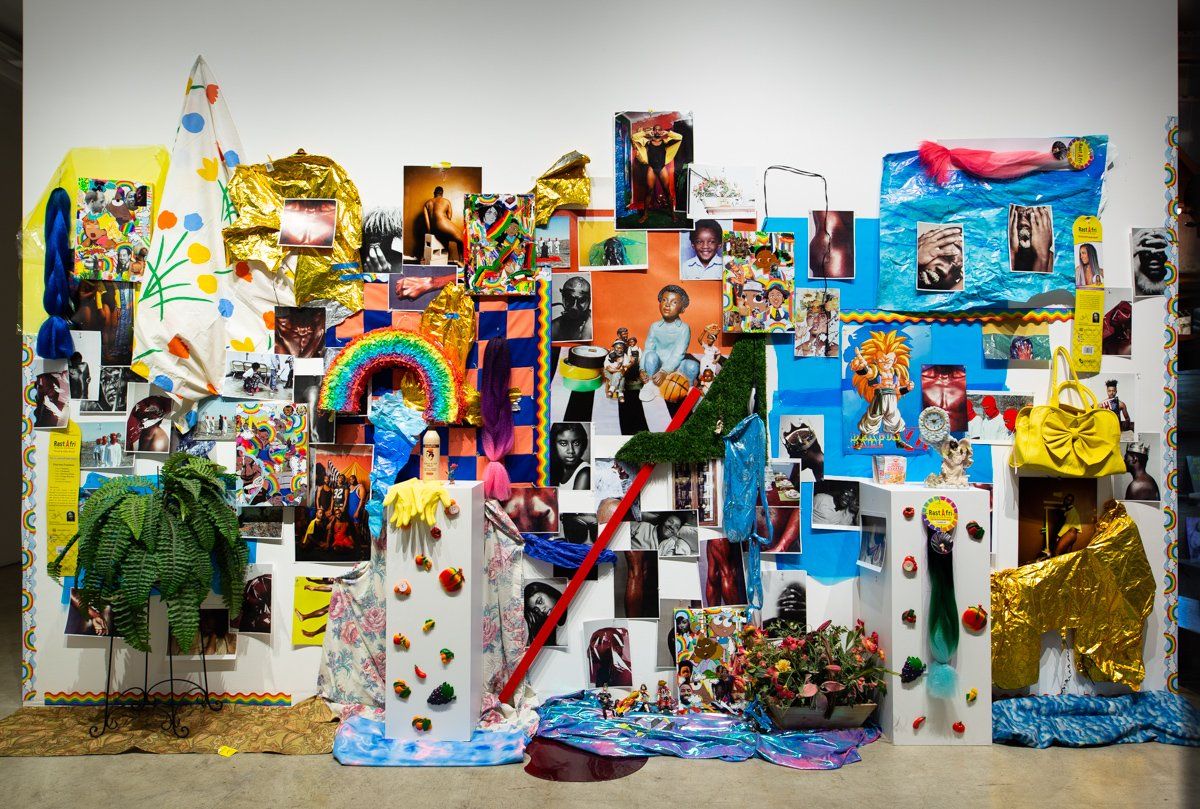 A wall with a lot of paintings and pictures on it.