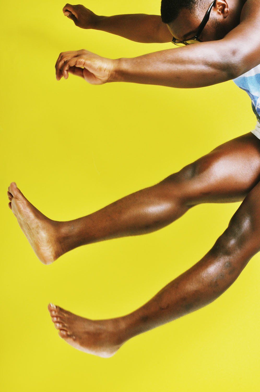 A man is jumping in the air with his legs outstretched