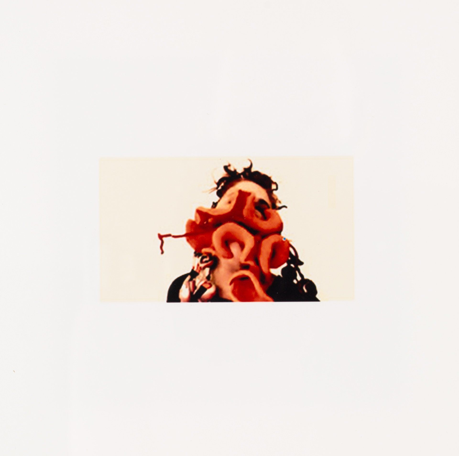 A close up of a person 's face with red letters on it.