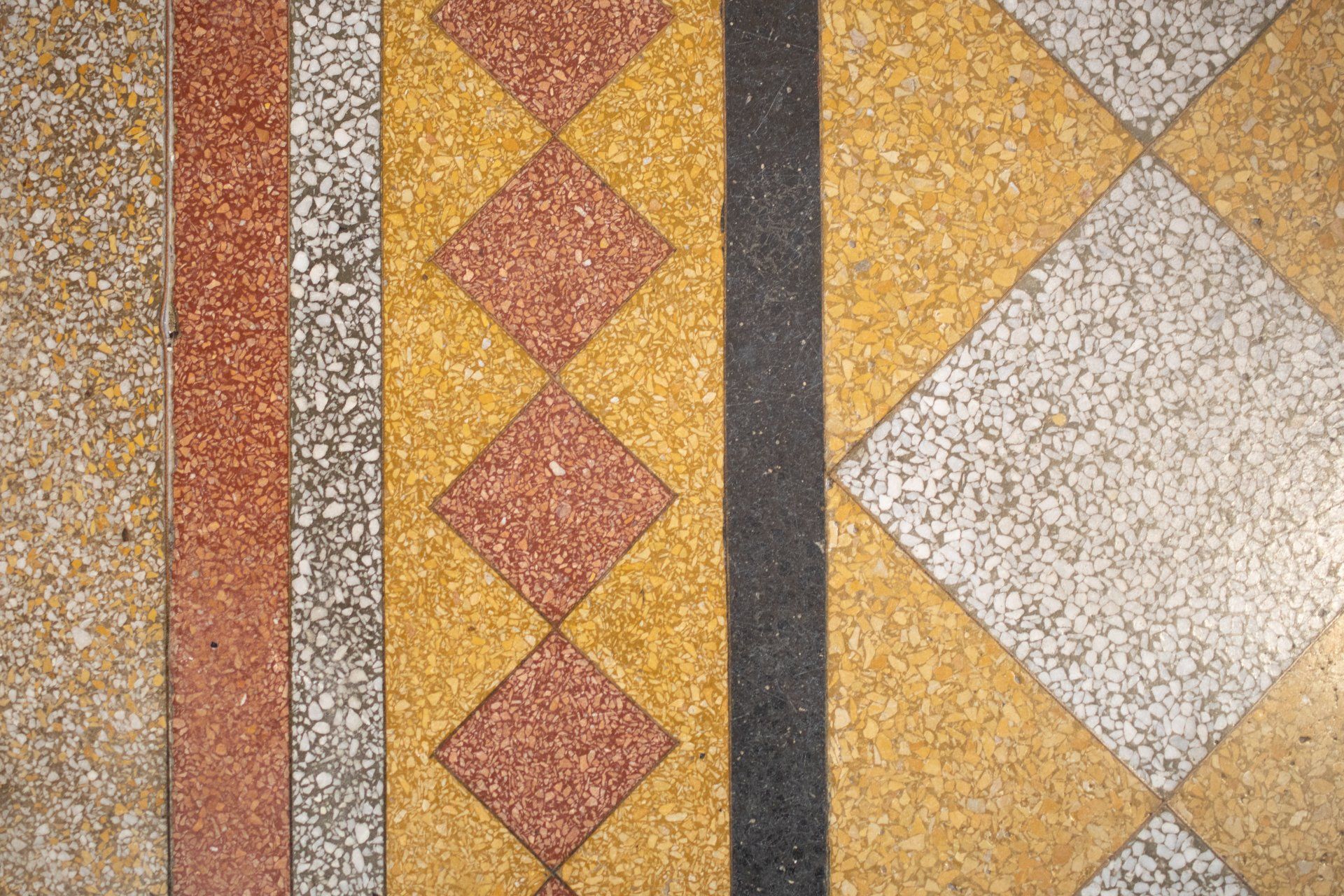 a close up of a tiled floor with different colored tiles