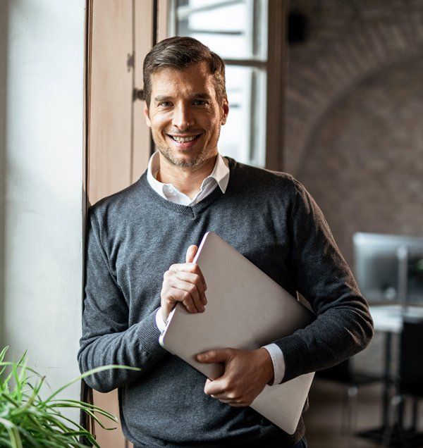 Businessman Holding Laptop — Old Bridge, NJ — Edward Testino, Attorney at Law