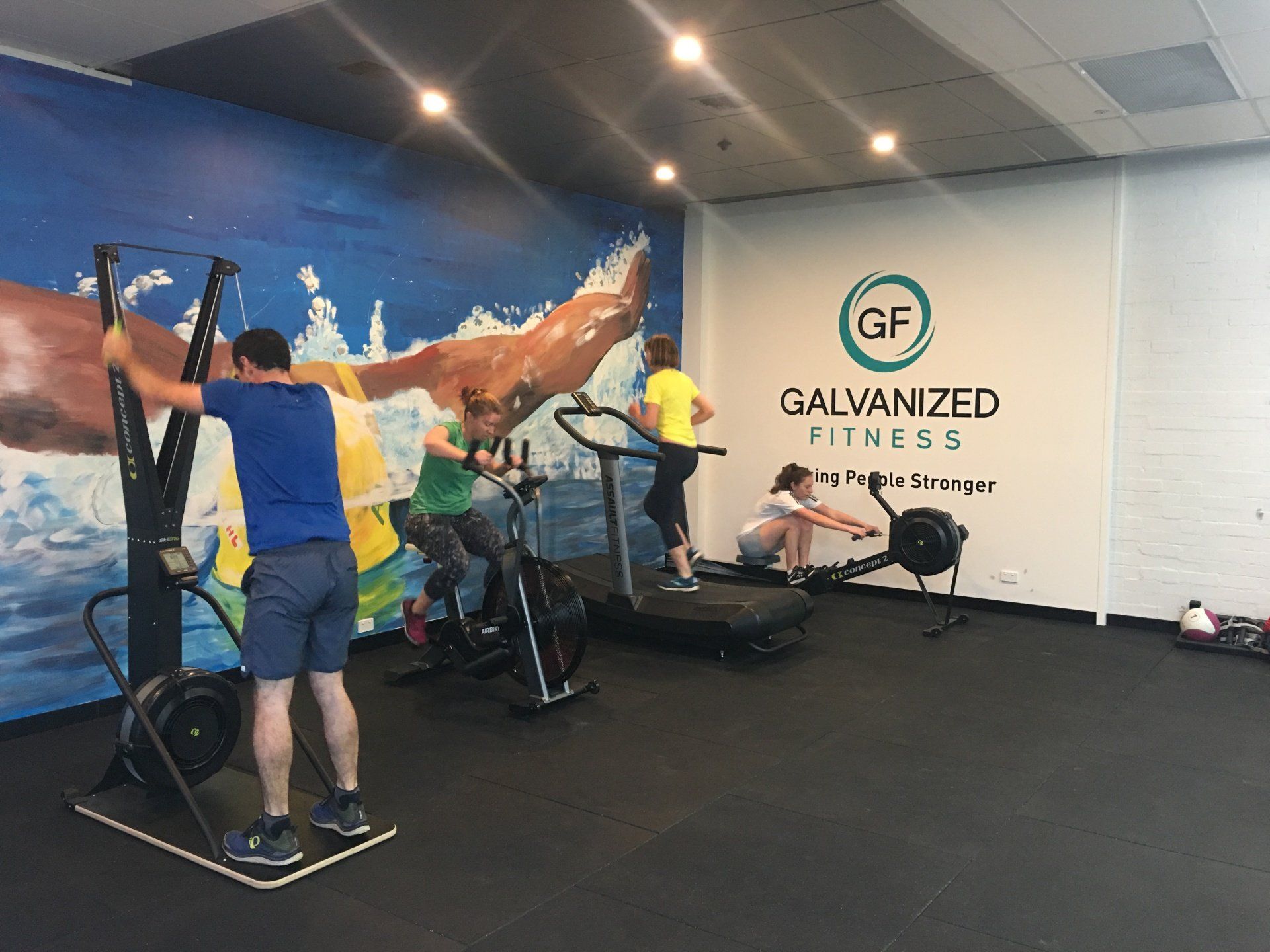 A group of people are working out in a gym.