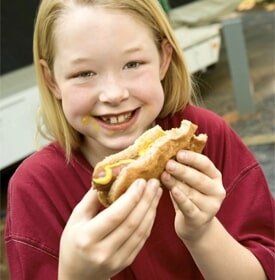 Girl Eating hotdog — Camping in Peroria, IL Girl Eating hotdog — Camping in Peroria, IL