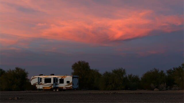 Large RV Against Sunset Clouds — RV Parking in Peroria, IL Large RV Against Sunset Clouds — RV Parking in Peroria, IL