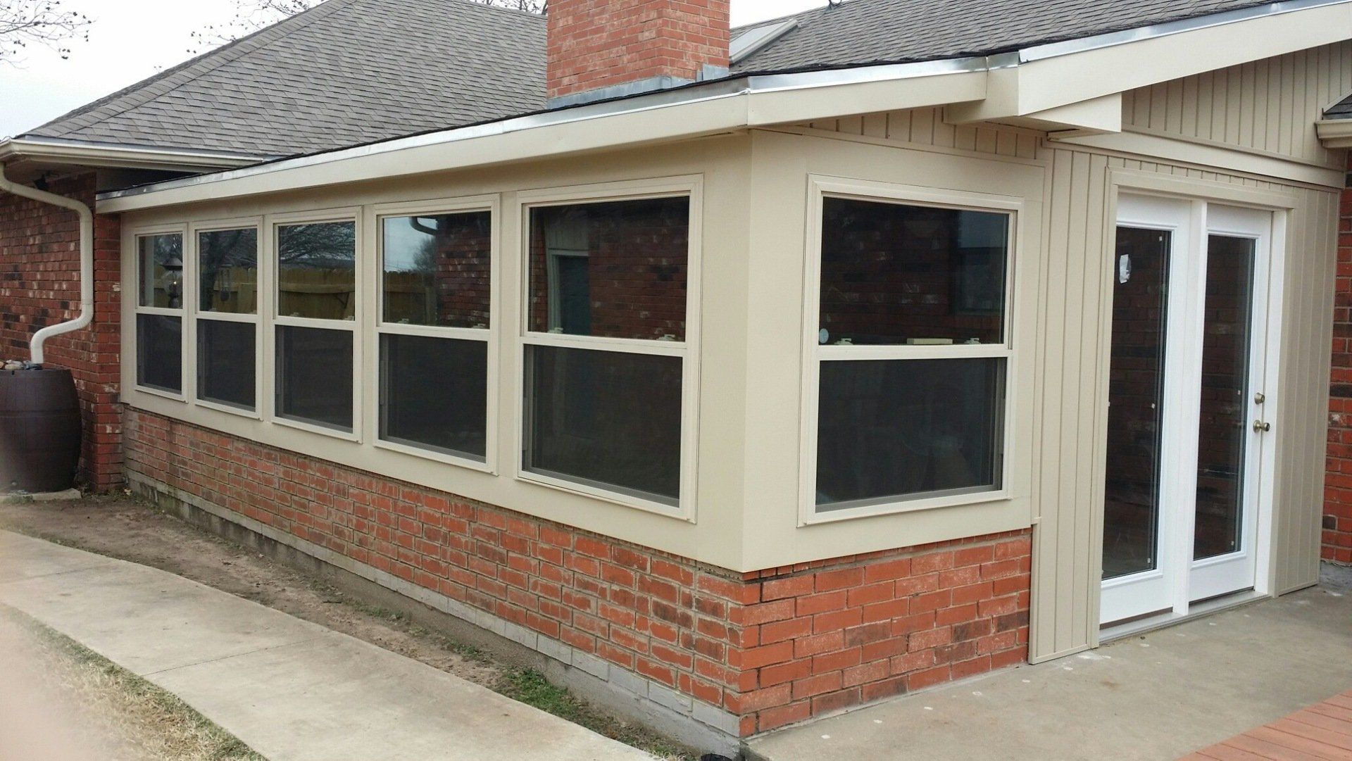 beige house red brick trim