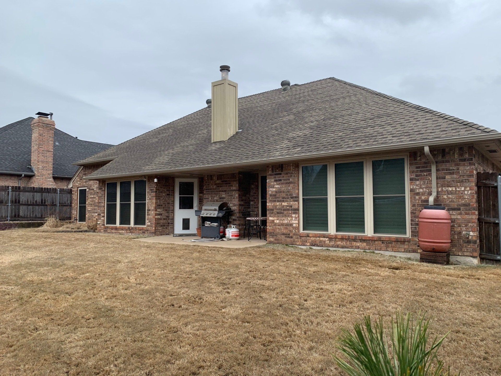 back of large brick ranch home