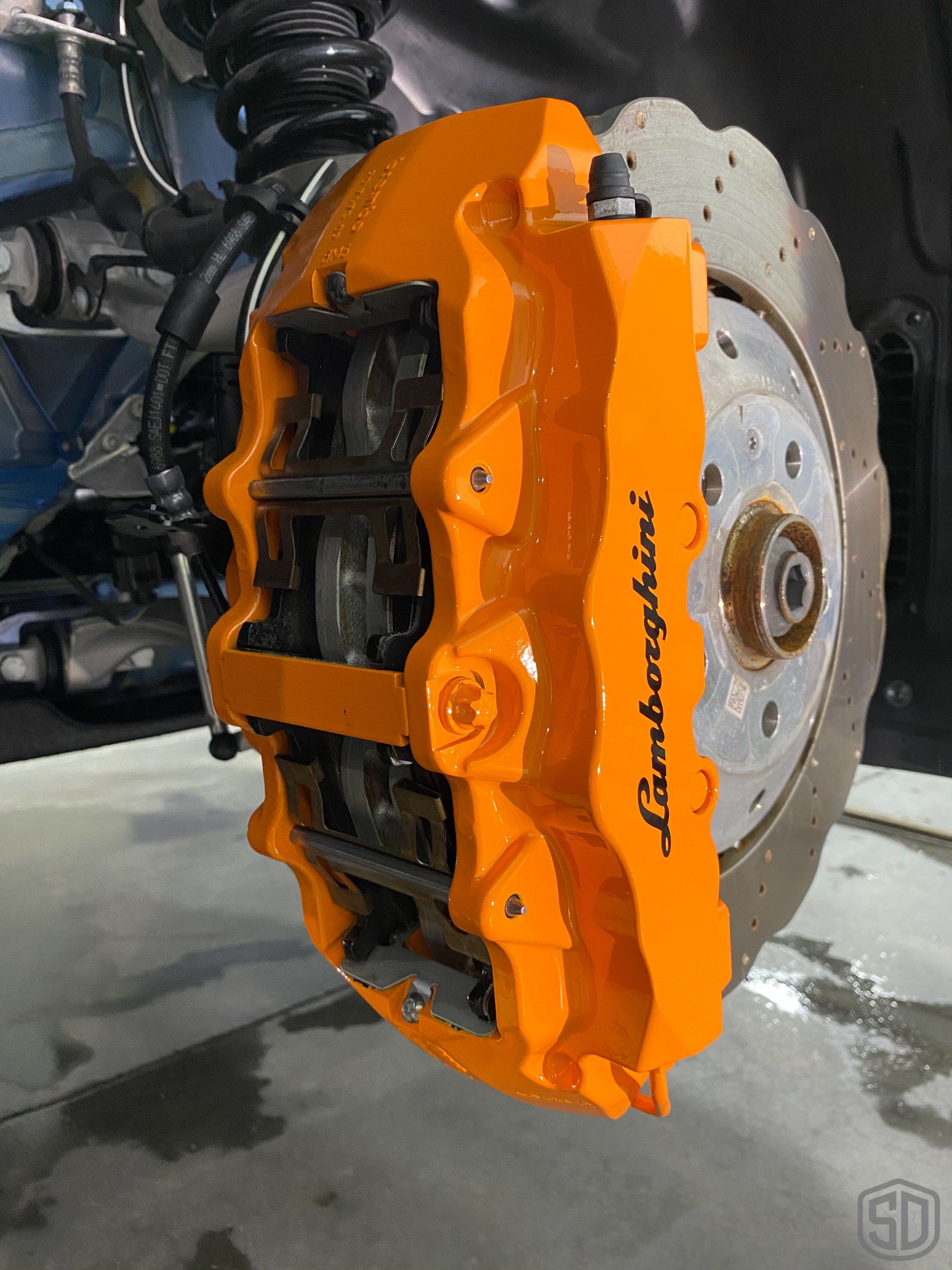 A close up of a lamborghini brake caliper on a car