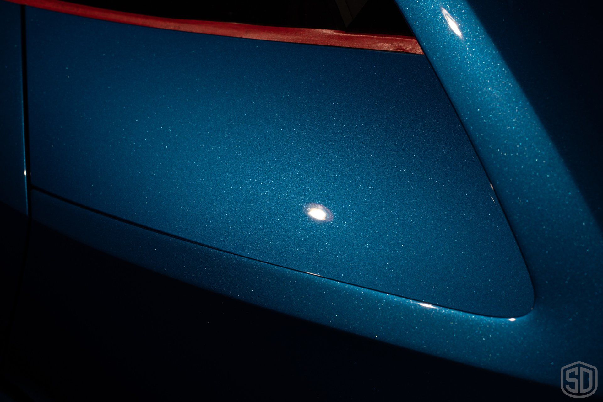 A close up of a blue car with sd written on the bottom