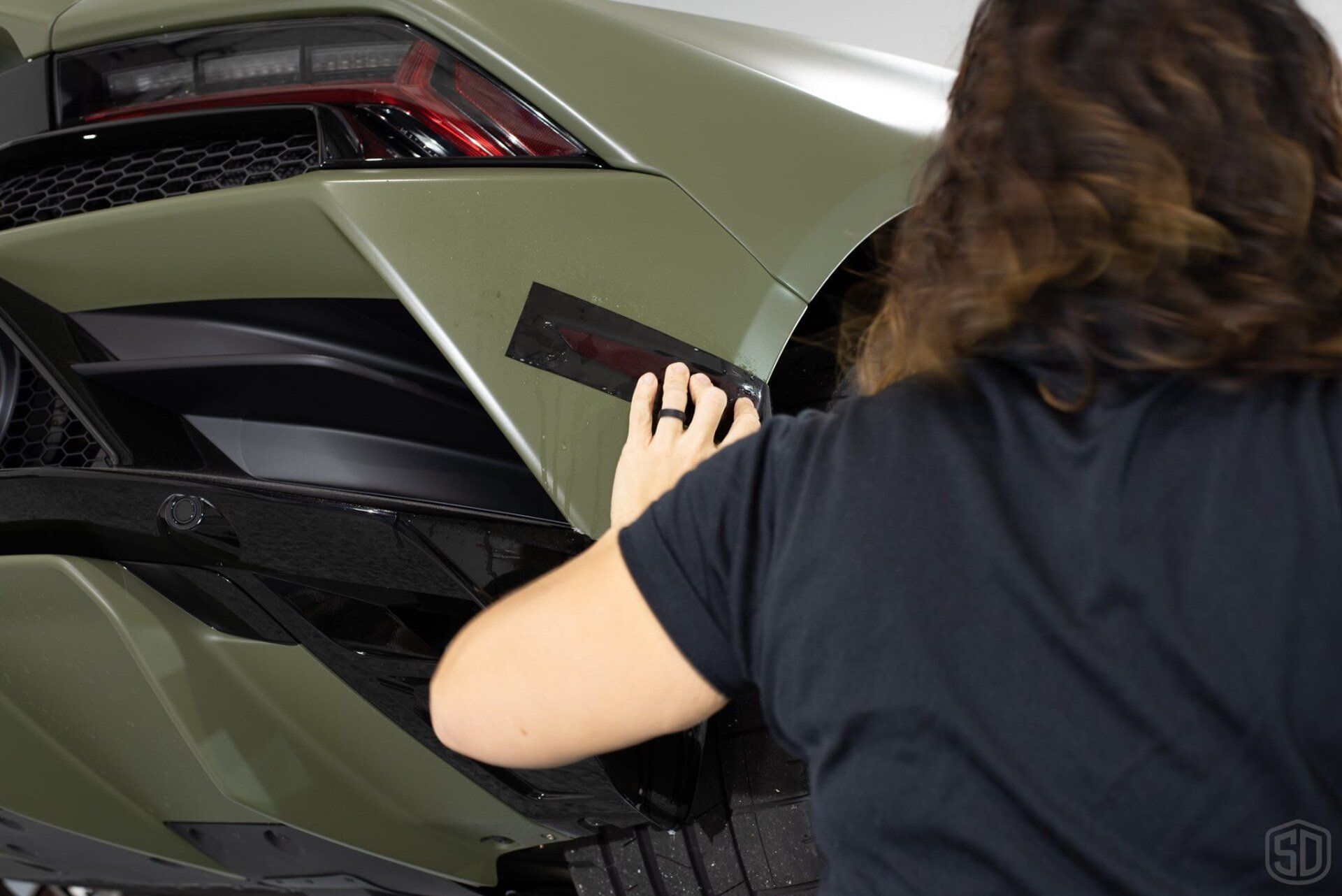 kim installing smoked paint protection film to market lights