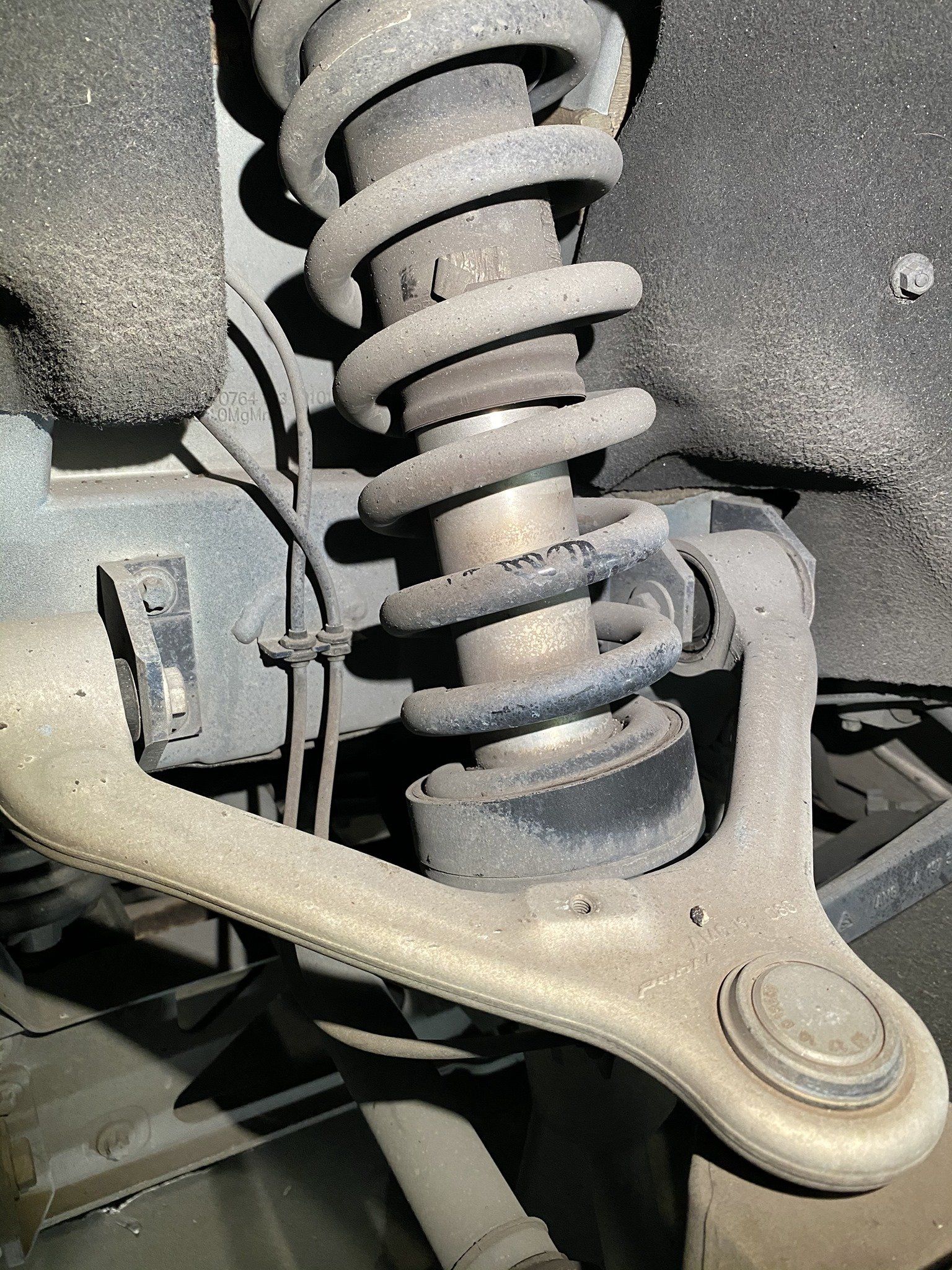 A close up of a shock absorber on a car.