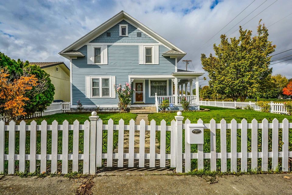 blue home with fence