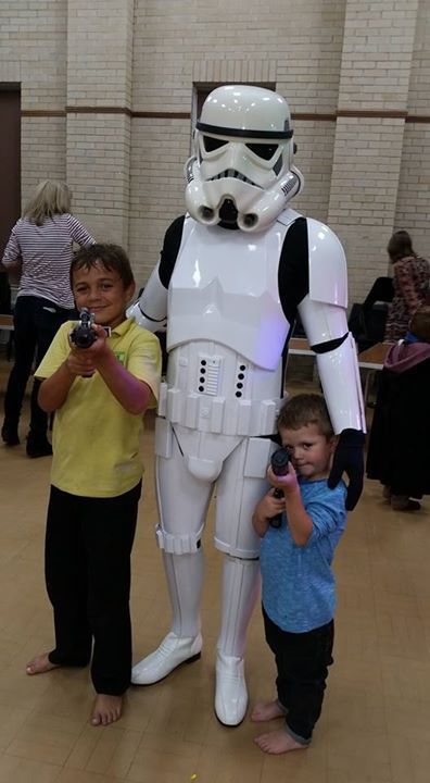 Young kids with a man wearing a costume