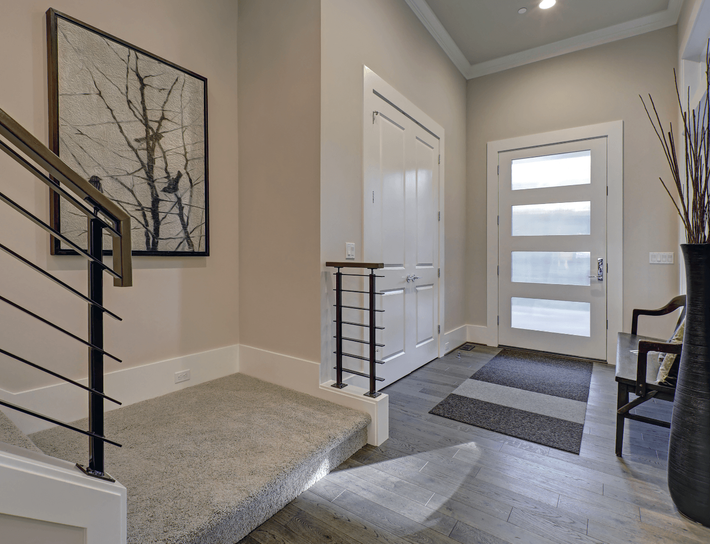 This is a picture of a new front entrance door.  The door is white with a modern look.