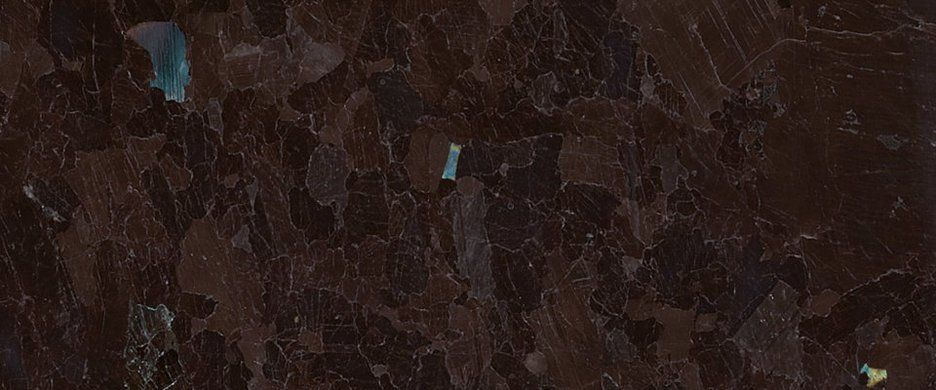 A dark brown, textured surface with reflective, crystalline mineral inclusions and subtle gray veining.