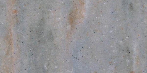 A close-up texture of gray marble stone with subtle tan veins and fine, scattered dark specks.