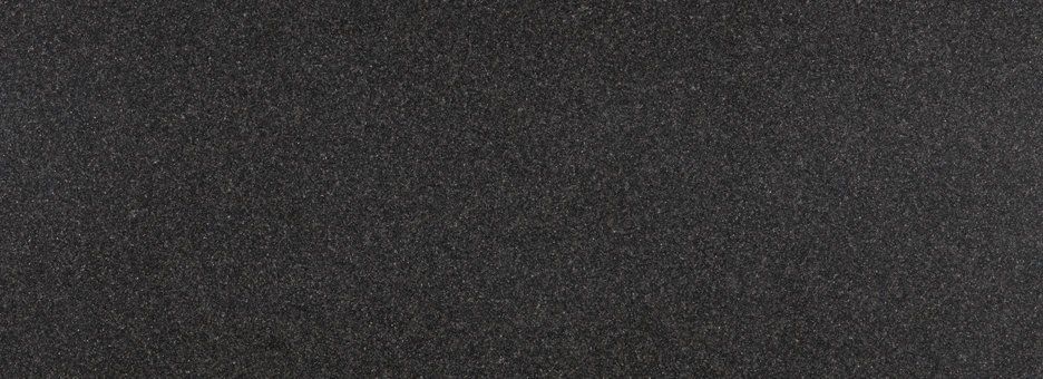 A solid, dark charcoal-grey background with a fine, granular texture.
