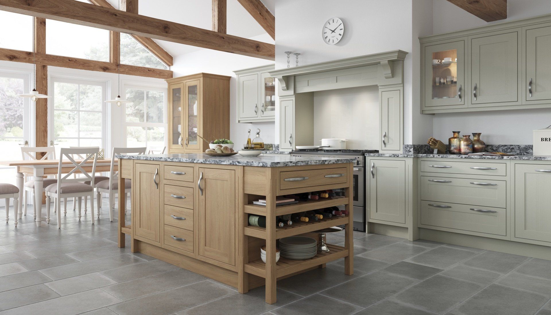 A kitchen with a wooden island, light-colored cabinets, and grey stone floors under a vaulted ceiling with exposed beams.