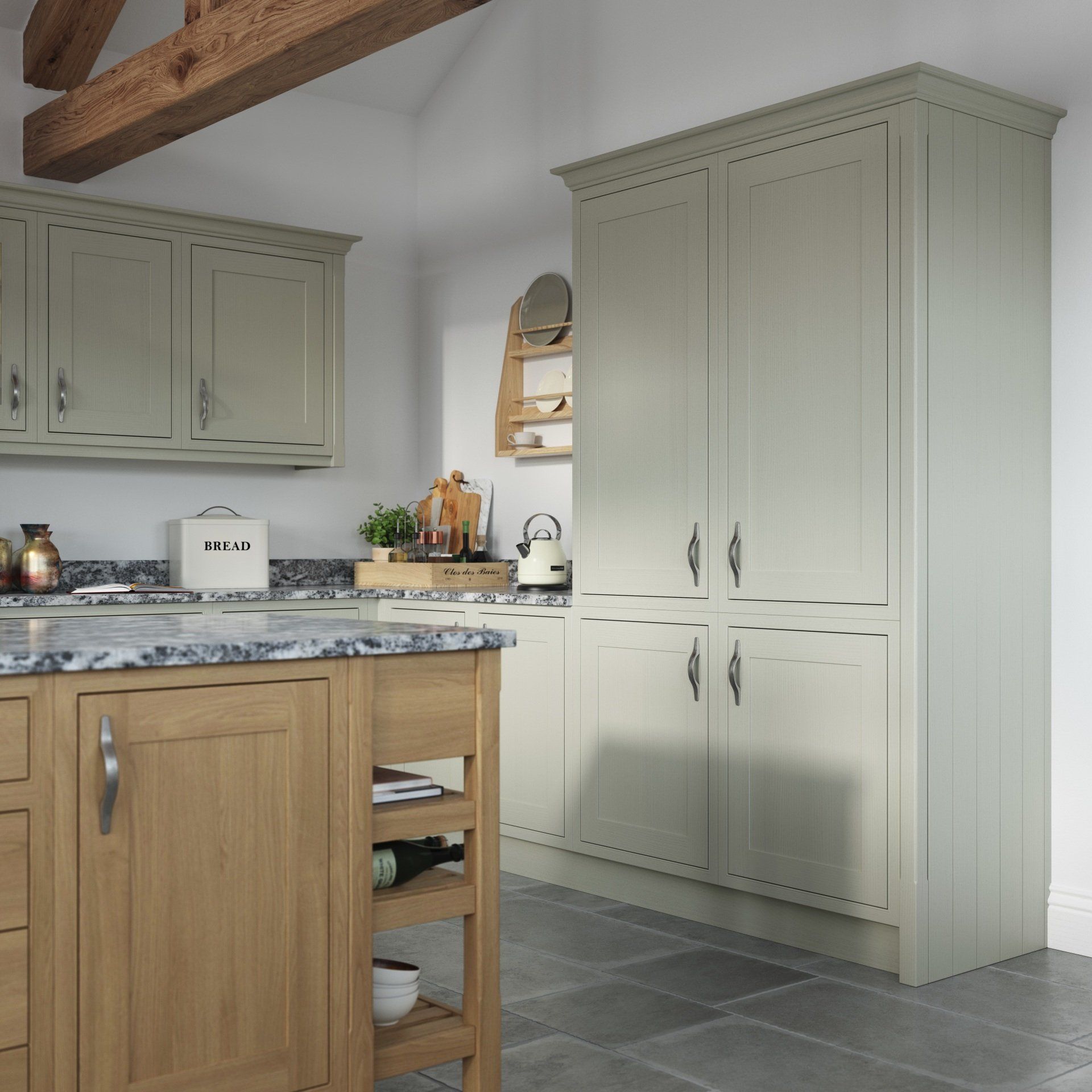 A kitchen featuring sage green cabinets, a wood-toned island with open shelving, and a prominent tall pantry cabinet.