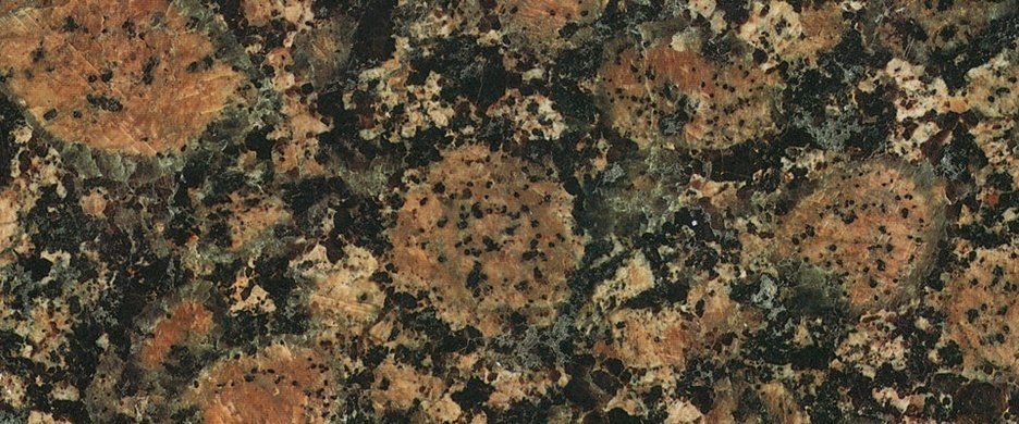 A close-up of brown and black granite stone featuring large, circular, mottled brown crystals set in a dark matrix.