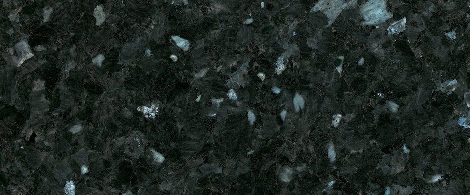 Dark granite countertop with a coarse, speckled texture in shades of black, charcoal, and iridescent blue-grey.