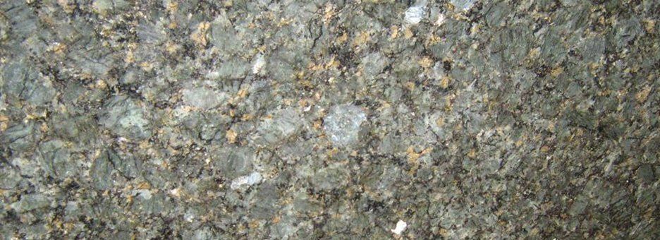 A close-up view of a grey and brown granite countertop surface with speckled mineral patterns.