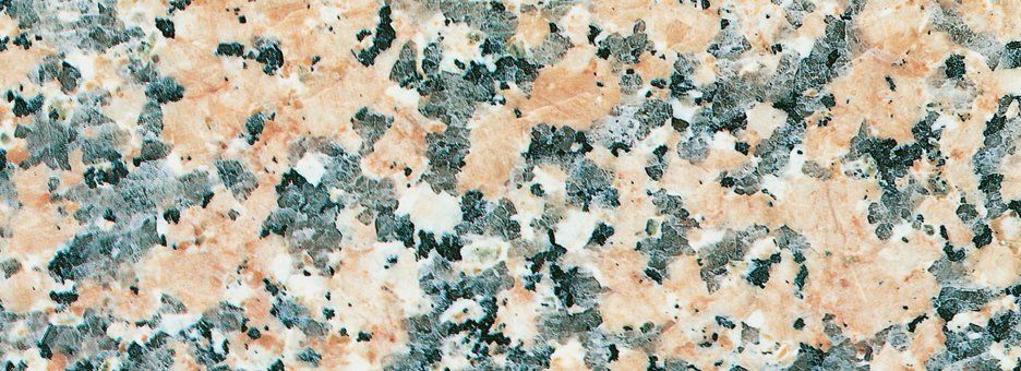 Close-up of pink and grey mottled granite stone texture.