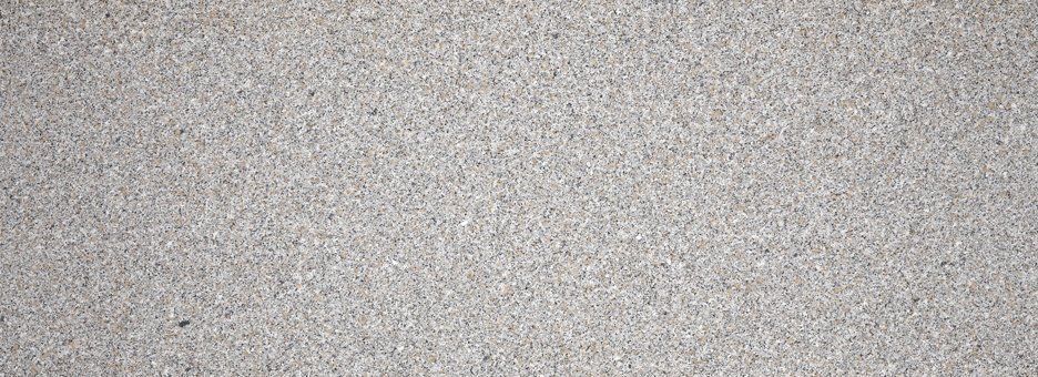 A light gray, speckled surface with a fine, uniform granular texture.