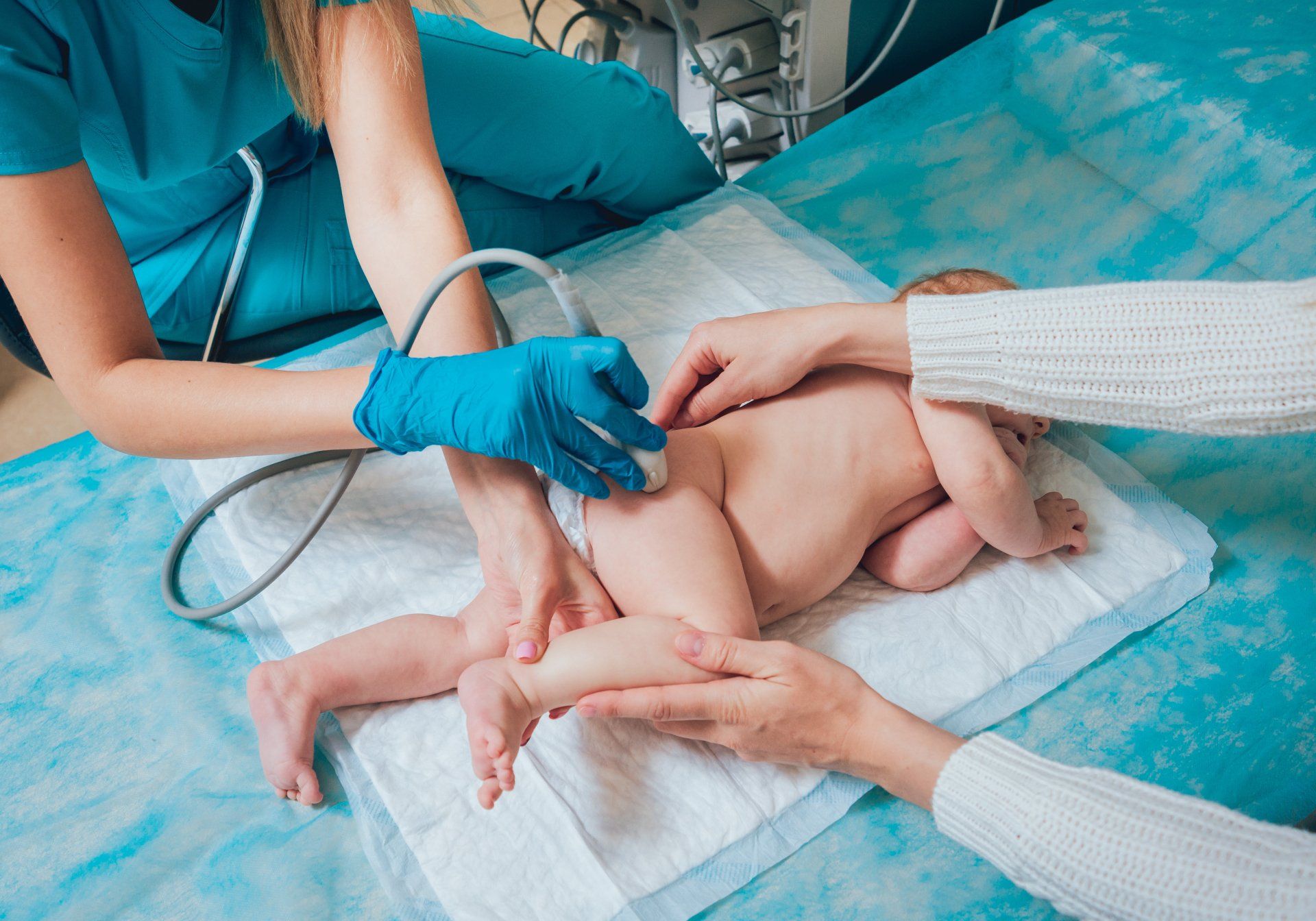 Ein Baby bekommt von einem Arzt eine Ultraschalluntersuchung.