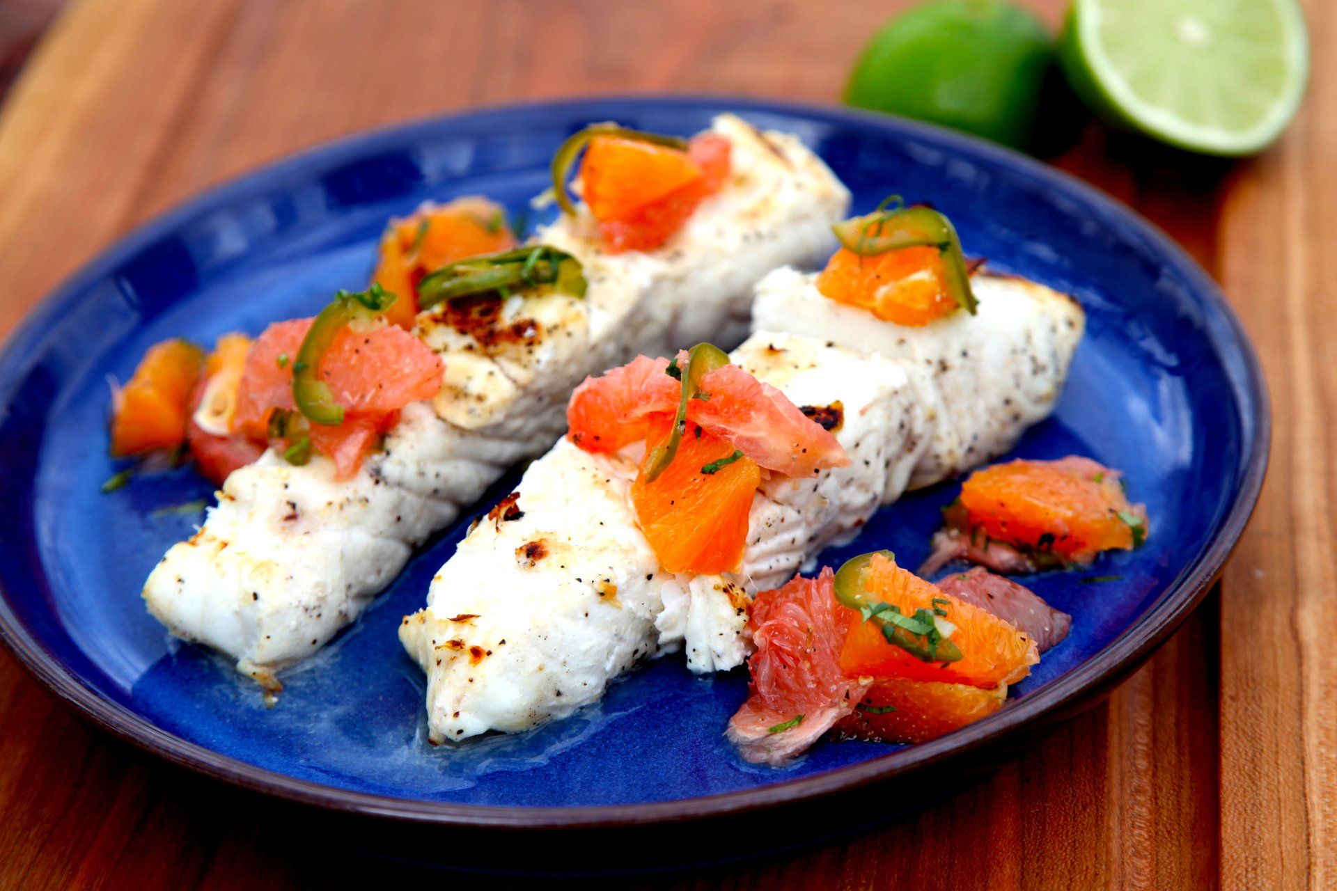 Plate of grilled mahi mahi topped with roasted Jalapeno salsa
