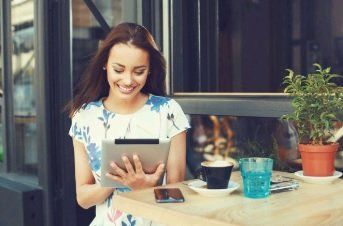 happy lady holding a tablet