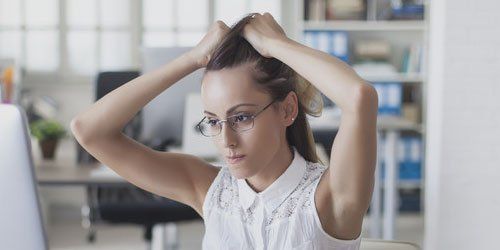 a lady holding her hair up